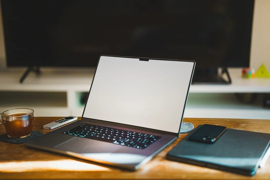 A contemporary workspace showcasing a laptop, tablet, and smartphones, ideal for tech and freelance use.